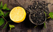 Is black tea acidic? Image of an acidic lemon next to a scoop of black tea