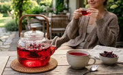 woman drinking hibiscus tea for skin on patio