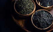 wooden bowls of oolong and black tea