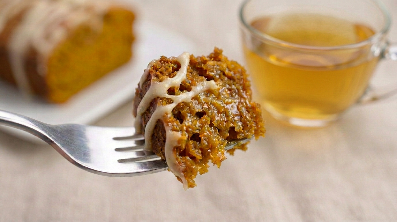 a bite of pumpkin chai tea loaf on a fork with cream cheese drizzle
